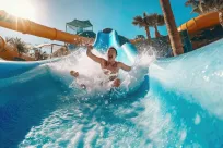 Male sliding down water slide