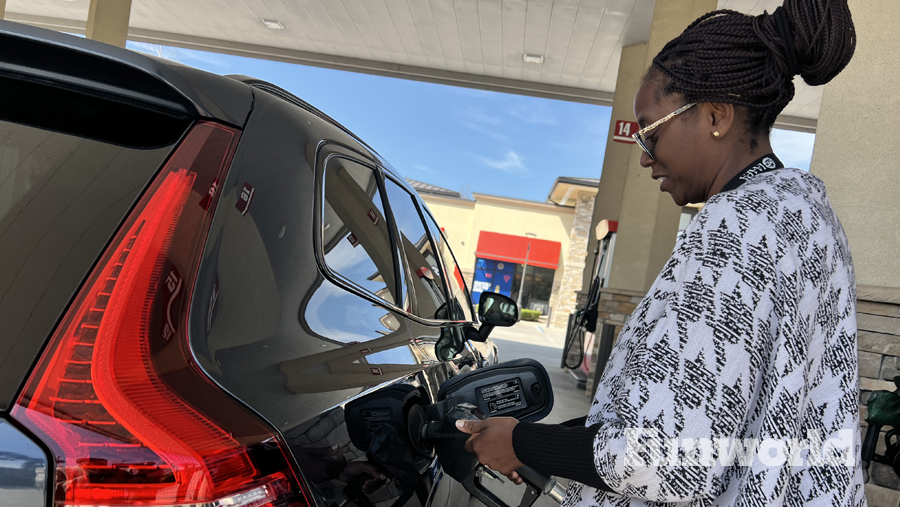woman fueling a vehicle at the gas pump