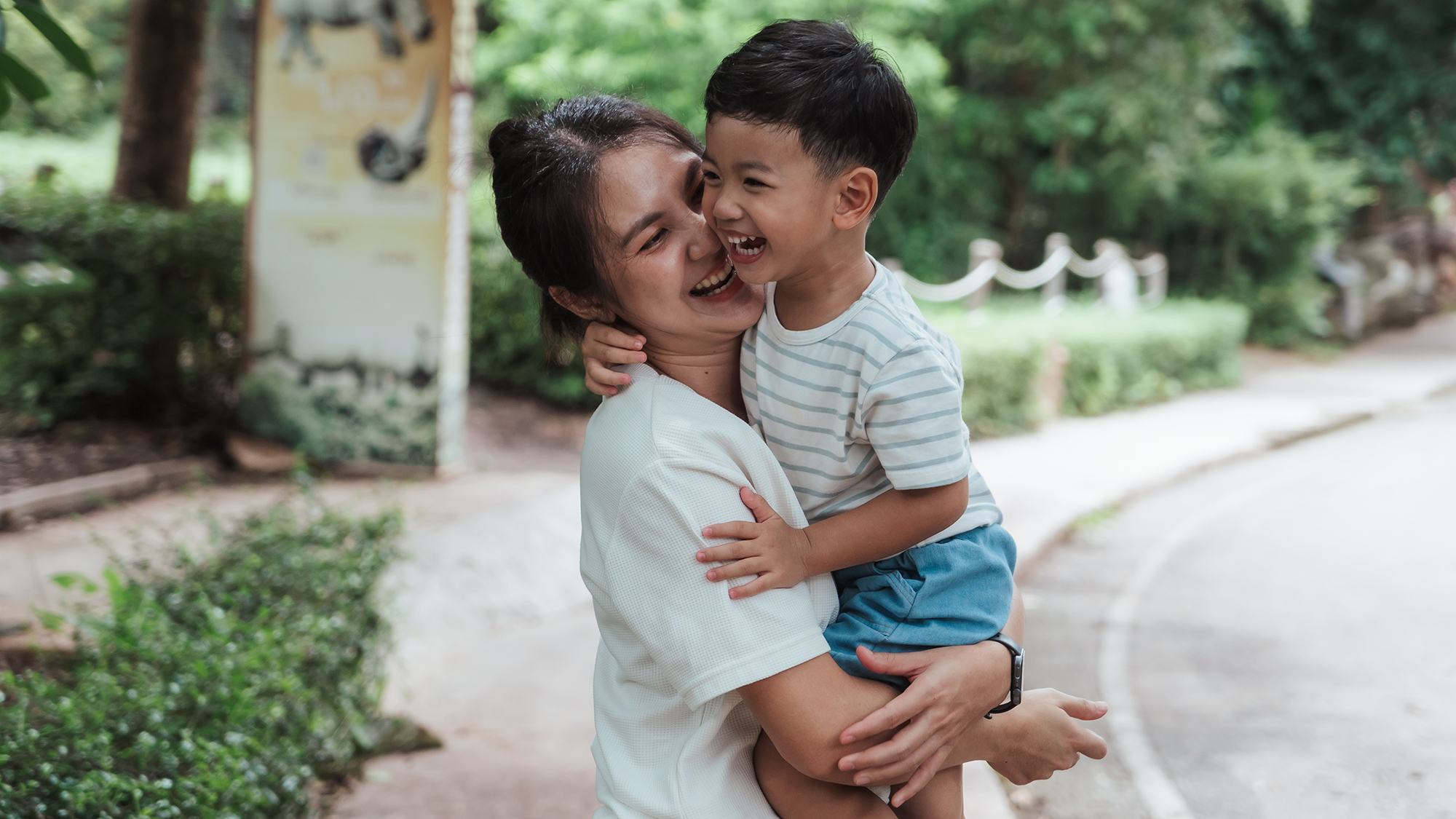 Mother and son hugging in a park