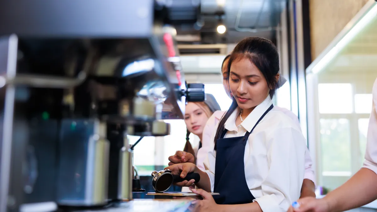 Barista learning to make coffee