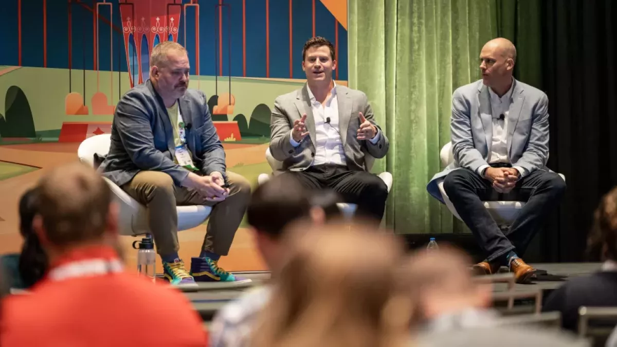 Three Gentlemen on stage discussing marketing automation