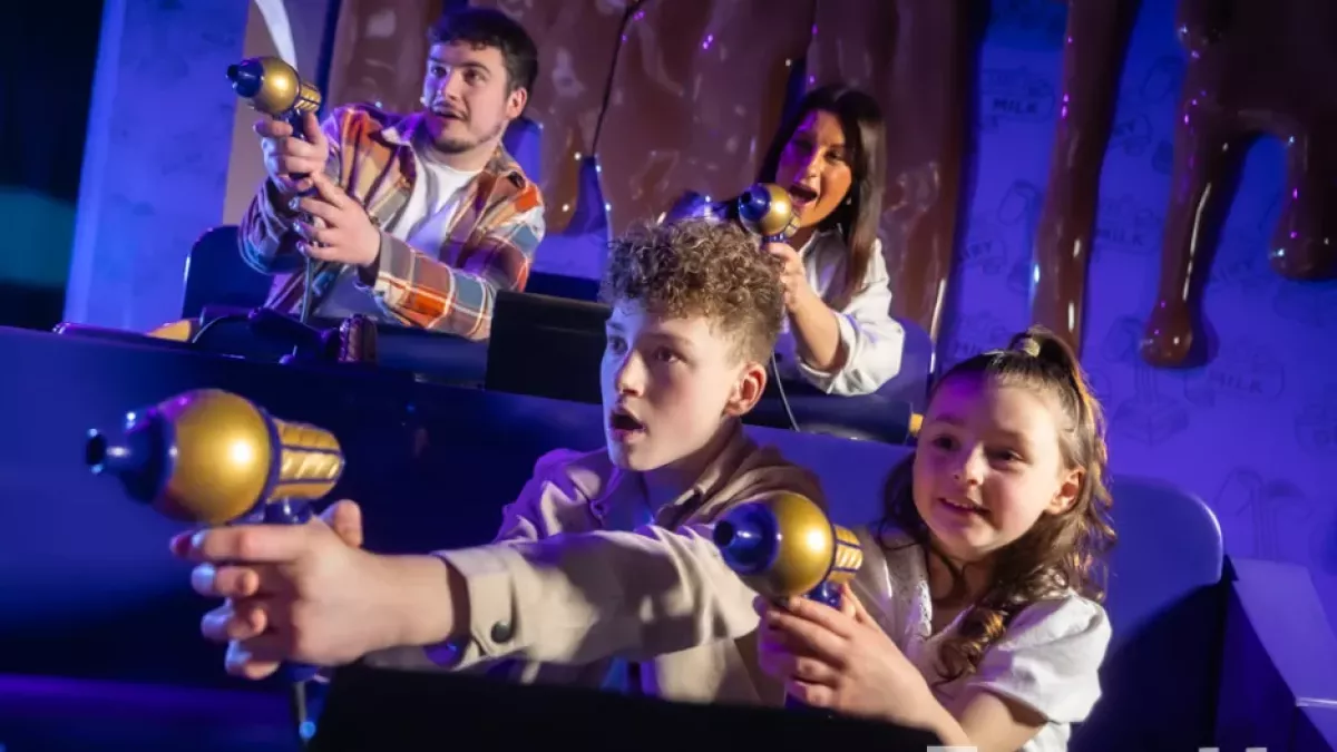 Cadbury Chocolate ride with a family playfully shooting at targets