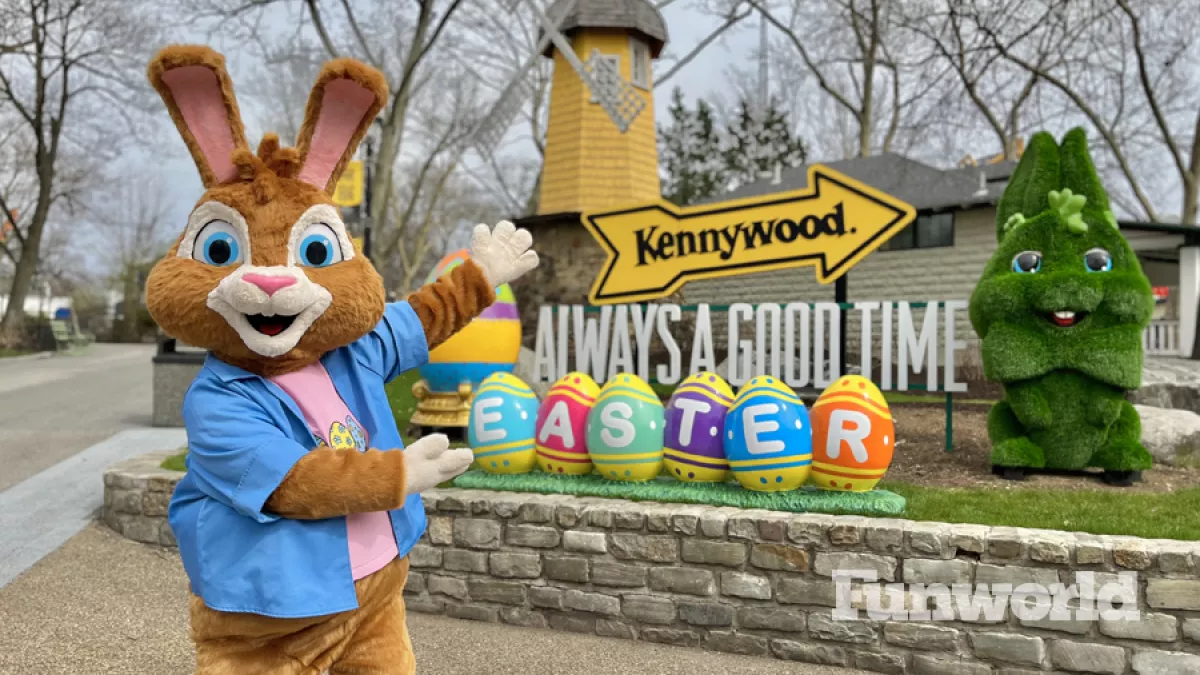 Kennywood Easter mascot Tuft poses in front of the kennywood sign and easter eggs