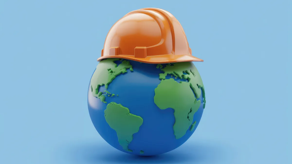 Global Safety Image with a model of earth with a construction hat on.