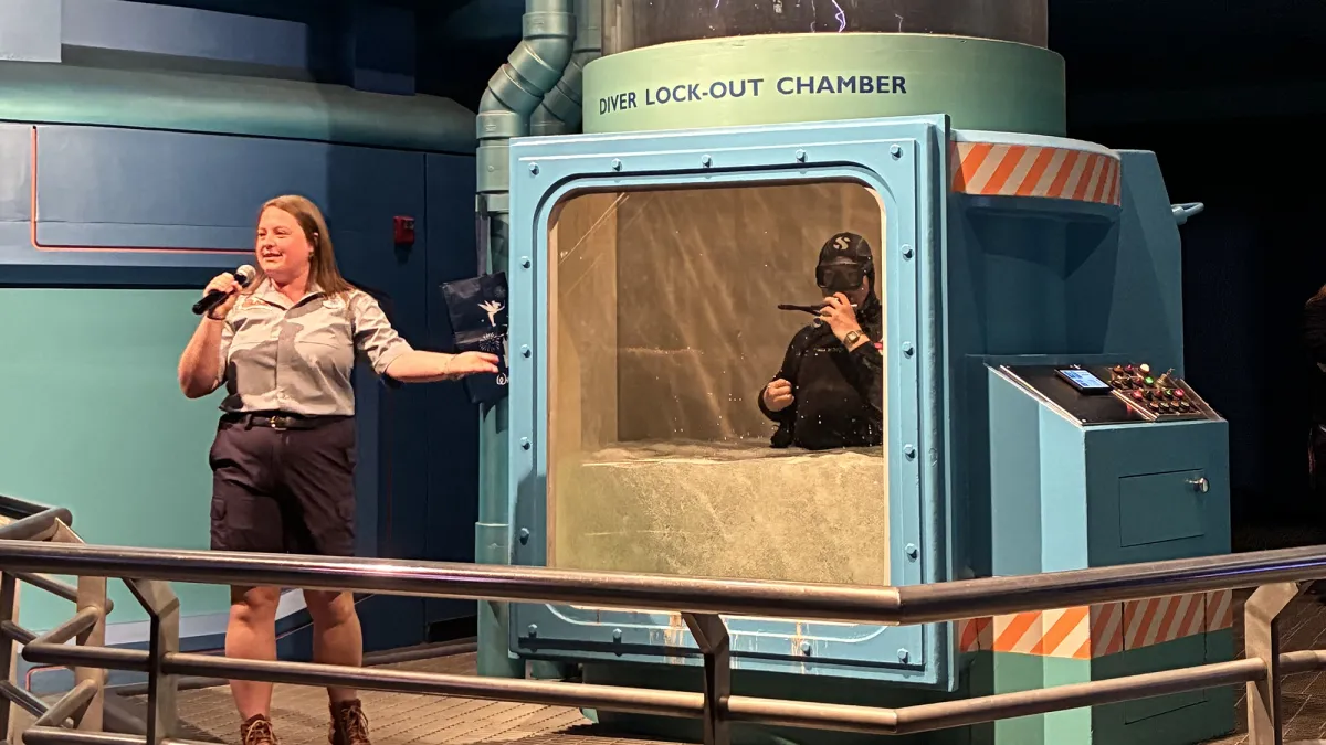 A Disney diver becomes submerged as part of a lockout chamber demonstration