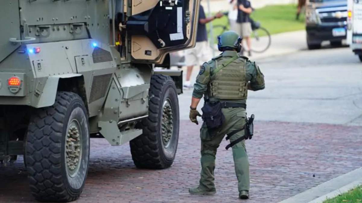 SWAT officer and vehicle pulls up to neighborhood to save trick or treating event.