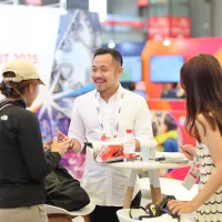 Attendees visit an exhibitor booth during IAAPA Expo Asia