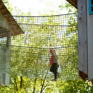 Little girl climbing to a tree house