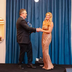 Blonde accepting an award smiling
