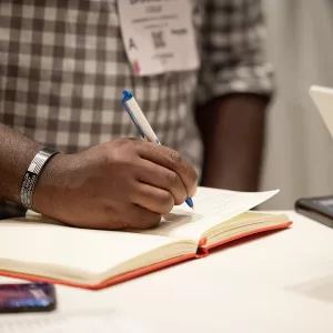 A person writing in a notebook