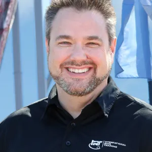 Man with black polo shirt with International Ride Training logo