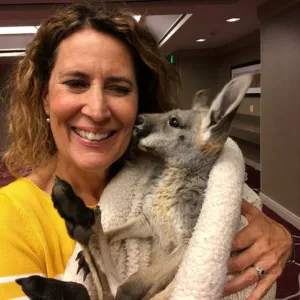 Woman holding baby kangaroo