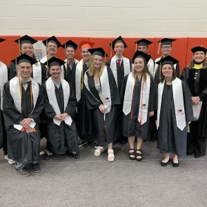The faces of Bowling Green's Class of 2025 with caps and gowns on at graduation