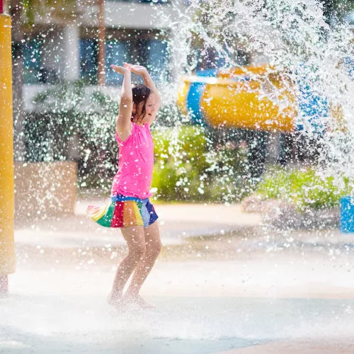 Girl playing at a splash pad