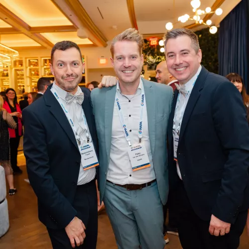 3 European men smiling at camera