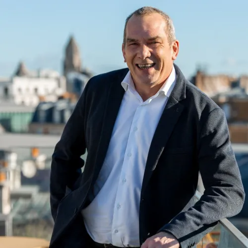 A picture of Pierre Chanet leaning against a railing casually