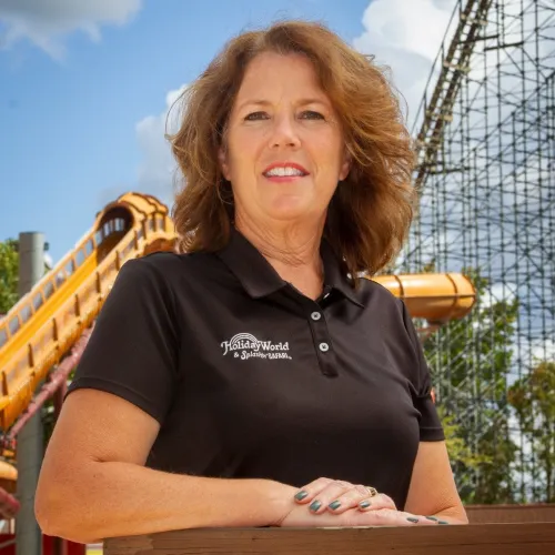 woman smiling with black polo and Holiday World & Splashin' Safari logo