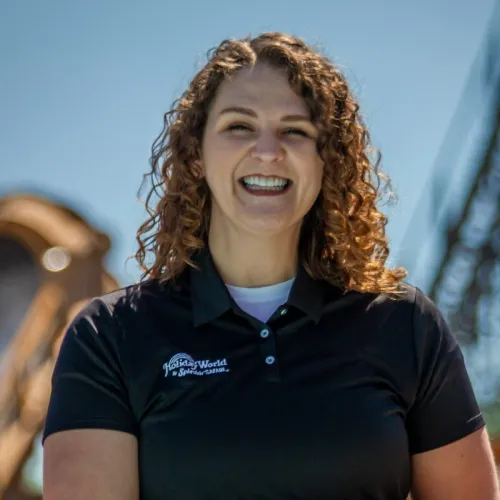 woman smiling with black polo and Holiday World & Splashin' Safari logo