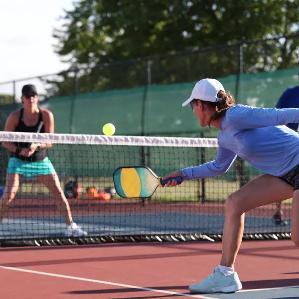Pickleball dink shot by female player