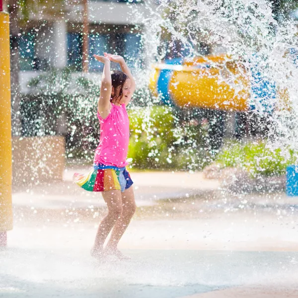 Girl playing at a splash pad