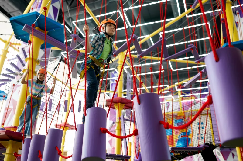 Children climb on little climber in an indoor gym