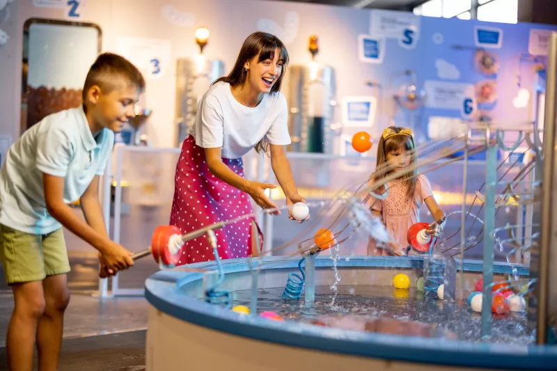 Mom & Kids playing at science museum