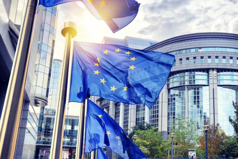 EU flags waving in front of European Parliament Building in Brussels, Belgium