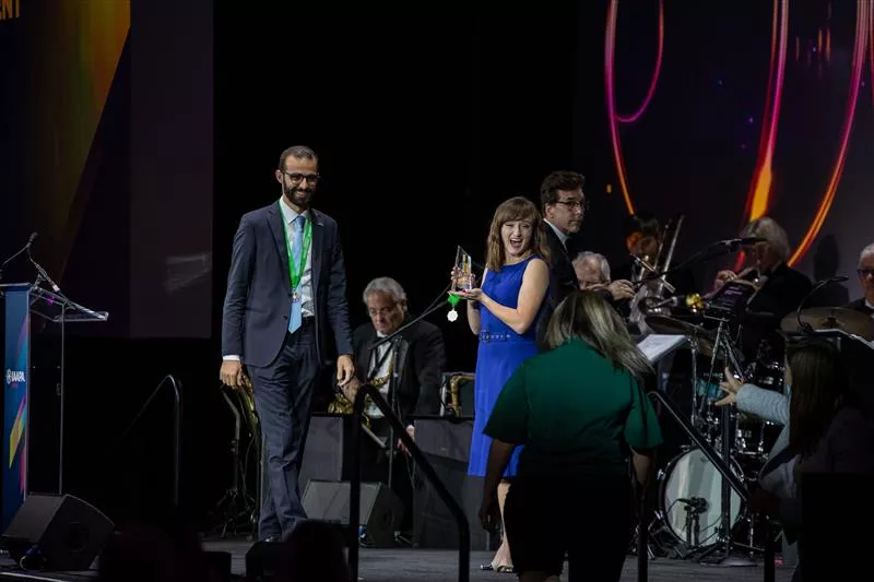 Man walking across stage to accept award