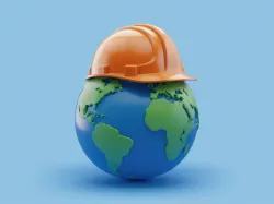Global Safety Image with a model of earth with a construction hat on.