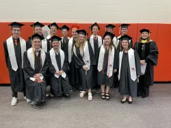 The faces of Bowling Green's Class of 2025 with caps and gowns on at graduation