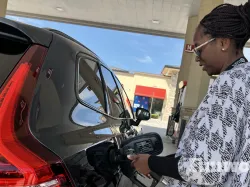woman fueling a vehicle at the gas pump