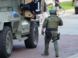 SWAT officer and vehicle pulls up to neighborhood to save trick or treating event.