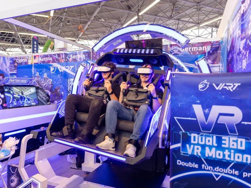 Attendees riding a VR Motion Simulator at IAAPA Expo