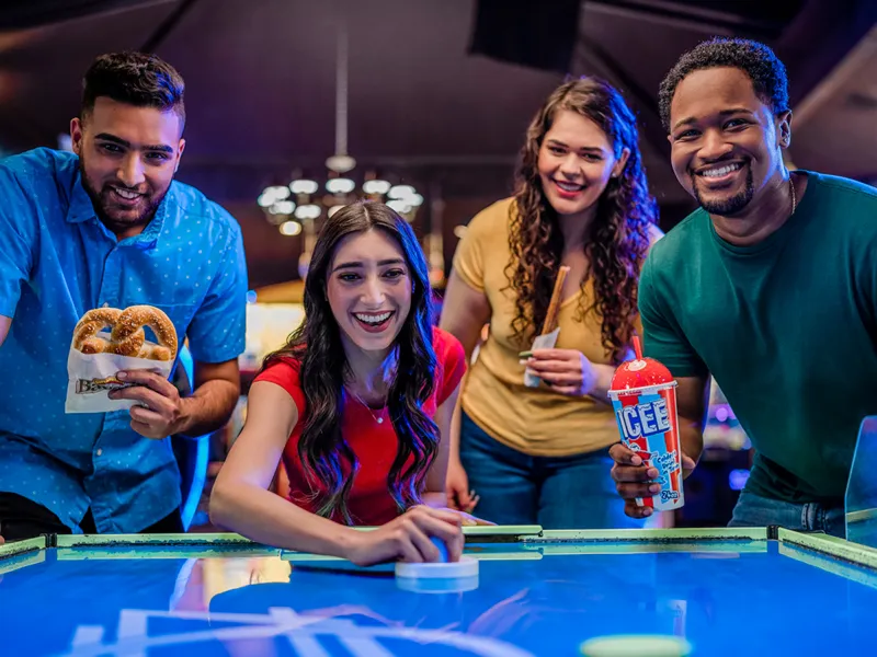 Group playing air hockey
