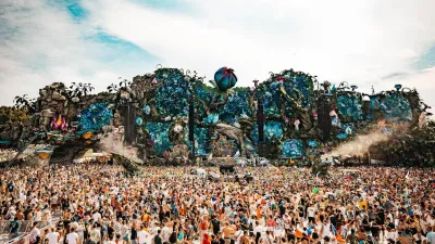 Massive audience gathered in front of a very large and elaborate Tomorrowland festival stage