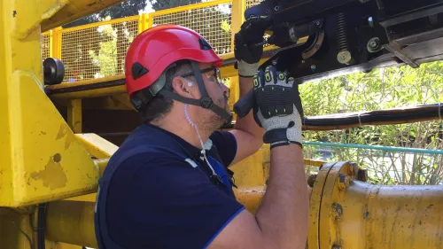 Maintenance Worker Inspecting Rollercoaster Mechanical System