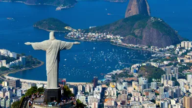 Christ the reformer statue gazing over a Brazilian harbor
