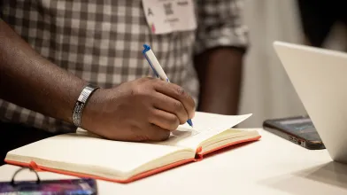 A person writing in a notebook