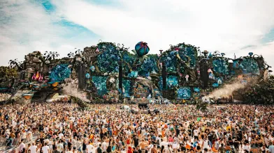Massive audience gathered in front of a very large and elaborate Tomorrowland festival stage