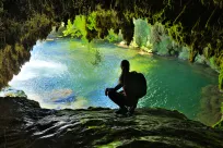 Man exploring in a cave with water