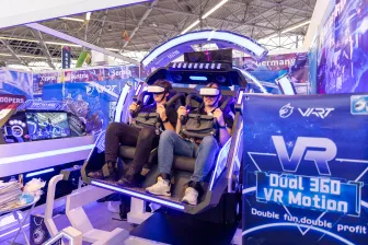 Attendees riding a VR Motion Simulator at IAAPA Expo