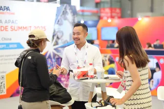 Attendees visit an exhibitor booth during IAAPA Expo Asia