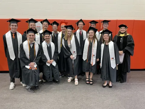 The faces of Bowling Green's Class of 2025 with caps and gowns on at graduation