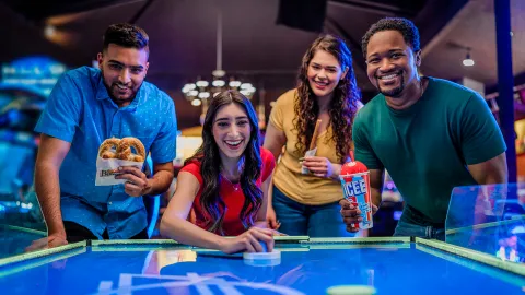Group playing air hockey
