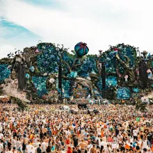 Massive audience gathered in front of a very large and elaborate Tomorrowland festival stage