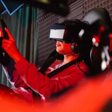 A person in a reclined position with a headset on using a gaming chair