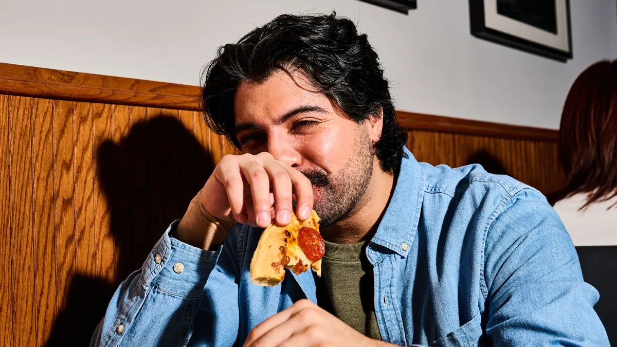 CJ Schwans Villa Prima Customer Eating Personal Pizza