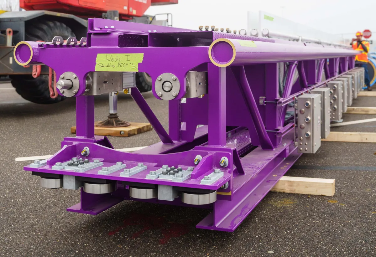 German handwriting appears on tape on the end of this piece of new roller coaster track. 